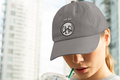 Custom distressed baseball hat in nickel gray color with LWPFC Club crest in black and gray.